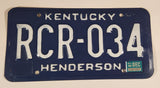 1987 Kentucky Henderson Dark Blue with White Letters Embossed Metal Vehicle License Plate Tag RCR 034