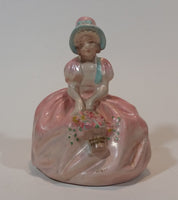 Vintage Chalkware Sitting Girl in Victorian Pink Dress with Bonnet and Flower Basket Figurine - Treasure Valley Antiques & Collectibles