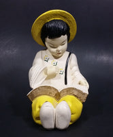 Vintage Chalkware Asian Child in Yellow Hat Sitting and Reading a Book Figurine - Treasure Valley Antiques & Collectibles