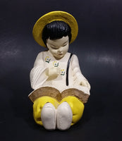 Vintage Chalkware Asian Child in Yellow Hat Sitting and Reading a Book Figurine - Treasure Valley Antiques & Collectibles