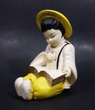 Vintage Chalkware Asian Child in Yellow Hat Sitting and Reading a Book Figurine - Treasure Valley Antiques & Collectibles