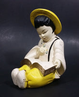 Vintage Chalkware Asian Child in Yellow Hat Sitting and Reading a Book Figurine - Treasure Valley Antiques & Collectibles