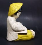 Vintage Chalkware Asian Child in Yellow Hat Sitting and Reading a Book Figurine - Treasure Valley Antiques & Collectibles