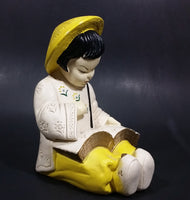 Vintage Chalkware Asian Child in Yellow Hat Sitting and Reading a Book Figurine - Treasure Valley Antiques & Collectibles