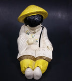 Vintage Chalkware Asian Child in Yellow Hat Sitting and Reading a Book Figurine - Treasure Valley Antiques & Collectibles