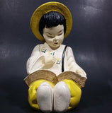 Vintage Chalkware Asian Child in Yellow Hat Sitting and Reading a Book Figurine - Treasure Valley Antiques & Collectibles