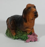 Vintage 1981 Dark Brown Hound Dog Holding Down a Pink Teddy Bear on Grass Collectible Figurine Numbered #714