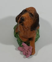 Vintage 1981 Dark Brown Hound Dog Holding Down a Pink Teddy Bear on Grass Collectible Figurine Numbered #714