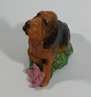 Vintage 1981 Dark Brown Hound Dog Holding Down a Pink Teddy Bear on Grass Collectible Figurine Numbered #714