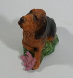 Vintage 1981 Dark Brown Hound Dog Holding Down a Pink Teddy Bear on Grass Collectible Figurine Numbered #714