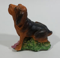 Vintage 1981 Dark Brown Hound Dog Holding Down a Pink Teddy Bear on Grass Collectible Figurine Numbered #714