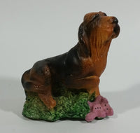 Vintage 1981 Dark Brown Hound Dog Holding Down a Pink Teddy Bear on Grass Collectible Figurine Numbered #714