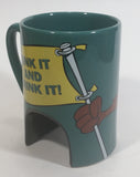 1998 Warner Bros Looney Tunes Taz Tasmanian Devil Cartoon Character "Sink It and Drink It!" Dark Green Ceramic Coffee Mug with Hole For Golf Ball Underneath