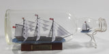 Vintage Highly Detailed HMS Surprise British Flagged Captured French Naval Tall Ship with Small Skiff Life Boat Sail Boat in 10 1/4" Long Glass Bottle