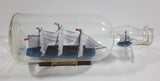 Vintage Highly Detailed HMS Surprise British Flagged Captured French Naval Tall Ship with Small Skiff Life Boat Sail Boat in 10 1/4" Long Glass Bottle