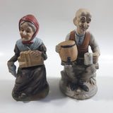 Old Man Sitting With Keg Barrel and Beer Stein and Old Woman Sitting with Umbrella and Packages Porcelain Figurines Set of 2