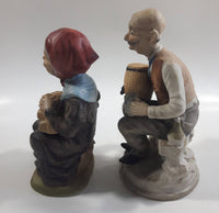 Old Man Sitting With Keg Barrel and Beer Stein and Old Woman Sitting with Umbrella and Packages Porcelain Figurines Set of 2