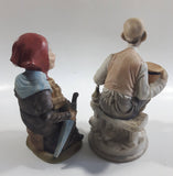 Old Man Sitting With Keg Barrel and Beer Stein and Old Woman Sitting with Umbrella and Packages Porcelain Figurines Set of 2