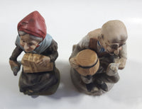 Old Man Sitting With Keg Barrel and Beer Stein and Old Woman Sitting with Umbrella and Packages Porcelain Figurines Set of 2