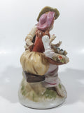 Vintage Man and Woman Sitting Holding Flowers 6 1/4" Tall Porcelain Figurine